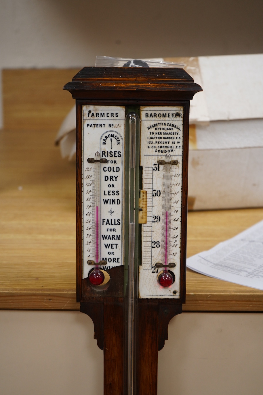 A Negretti and Zambra 'Farmer's' barometer, oak stick barometer with ceramic scales. Condition - fair, one scale broken with piece present.